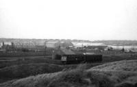 A class 24 with 2 fish vans on the Saturday morning goods to Aberdeen passes Kirkton cottage and cemetery about 1 mile south of Fraserburgh in 1972.<br><br>[John Williamson //1972]
