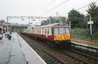 A 6-car 303 with a service to Dalmuir stands at Motherwell platform 4 in September 1997. <br><br>[David Panton 04/09/1997]