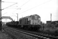 Empty mineral waggons heading to Faslane for loading with scrap metal being hauled west through Cardross by EE Type 1 no 8119 on 18 September 1972. The train will leave the West Highland line at Faslane Jct and traverse the line to No 1 Military Port where Shipbreaking Industries were cutting up various marine craft and, a few years earlier, steam locomotives.<br><br>[John McIntyre 18/09/1972]