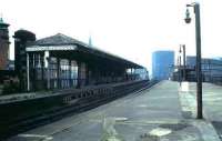 The disused ECML platforms at Manors station in 1985 looking west along platform 8 with 9 on the left. The subway at the end of the platform led down to a station entrance on the corner of Melbourne Street and Trafalgar Street and featured in an evocative scene from the 1971 film <I>'Get Carter'</I>. Platforms 6 & 7, beyond the fence on the right, are still used by a small number of local stopping services. [See image 13169]<br><br>[David Panton //1985]