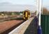 An Edinburgh - Bathgate service pulls into the platform at Uphall on 15 February 2008 as traffic continues west along the M8. Note the area now pegged around the site of the second platform as well as the work underway beyond in preparation for new infrastructure on the north side of the station.<br><br>[John Furnevel 15/02/2008]