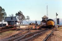 Corrour Summit, looking back to Corrour where an engineers inspection train is paused (for nearly an hour). The footbridge had been removed not long before. This was the day a Shackleton crashed in the Outer Hebrides.<br><br>[Ewan Crawford 01/05/1990]