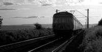 A evening 6 car eastbound service approaching Geilston level crossing just west of Cardross in 1973.<br><br>[John McIntyre //1973]