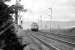 With the Argyll hills in the background a pair of Class 303 units approaches Geilston level crossing, west of Cardross, with an eastbound service in 1974.<br><br>[John McIntyre /03/1974]