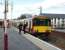 Driver changeover taking place at Garscadden on 19 April 2008 with 318 253 forming a service to Springburn.<br><br>[David Panton 19/04/2008]