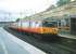 303 012 on a Carstairs service stands at Motherwell in July 1997.<br><br>[David Panton /07/1997]