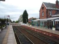 Start of the single line section to Hammerton (just beyond the crossing) on the York - Harrogate line. This view west shows the substantial modern waiting room added on to the original building on the York platform.<br><br>[Mark Bartlett 28/04/2008]