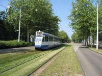 Track maintenance equipment in the Amsterdam suburbs must consist of a lawnmower! An Amsterdam tram heads towards the centre of town an a grassy reserved trackbed.<br><br>[Michael Gibb 21/05/2008]