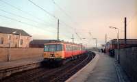 303 064 heading for Airdrie at Partick as the sun sets.<br><br>[Ewan Crawford //1987]