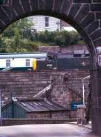 Viewed through the western arch of the Wellington suspension bridge, 40106 (in green) moves slowly past on its way to Ferryhill shed, Aberdeen in 1975.<br><br>[John McIntyre //1975]
