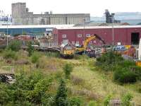 67022 with an engineers train being loaded with building materials at a rather overgrown Leith South yard on 21 August 2007. View is northwest towards the docks. The materials were for use on the improvement works being carried out at Waverley at that time.<br><br>[Mark Poustie 21/08/2007]