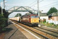 The morning Powderhall - Oxwellmains <I>Binliner</I> containers run east through Prestonpans in June 1999 behind 56 059. <br><br>[David Panton /06/1999]