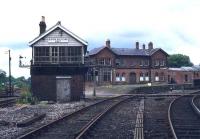 The once important station and Junction at Bishop Auckland seen from the southeast in 1977. The photograph shows the lines to Durham curving off to platforms 2 & 3 on the right, with the covered platform 1, serving the Crook and Weardale lines, straight ahead beyond (and obscured by) the signal box. On the far side of the station the north to west platform 4 completed the triangle, although this was used mainly for the 3 Ps - parcels, pigeons and papers. By the time of this photograph the former hub in western County Durham had lost most of its services and become a candidate for <I>major rationalisation</I>. [See image 31091]<br><br>[Ian Dinmore //1977]