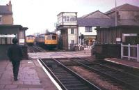 Looking east towards Blackburn from Bamber Bridge station in September 1978 as a pair of Cravens DMUs pass on the Preston - Colne route. The buildings at the end of the platforms on either side of the level crossing gave access to a pedestrian subway. The subway was filled in and the associated structures demolished in 2005/6. The signal box still stands but nowadays controls only this crossing and another at nearby Hospital Inn. <br><br>[Mark Bartlett /09/1978]