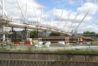 A train for Glasgow Queen Street leaving Stirling on 12 June and passing under work in progress on the new footbridge spanning the south end of the station.<br><br>[John Furnevel 12/06/2008]