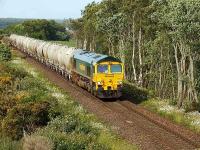 Freightliner liveried 66613 climbs towards Daviot with a southbound train of cement wagons on 26 June 2008.<br><br>[John Gray 26/06/2008]