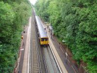 There are four trains an hour in each direction serving Aughton Park. This is the view towards Ormskirk from alongside the ticket office on 29 June 2008 with 507019 standing at the platform on a service to Liverpool Central. From here two very steep paths lead down the cutting sides to the platforms. <br><br>[Mark Bartlett 28/06/2008]