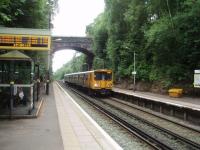 Situated in a deep cutting, Aughton Park station opened in 1907, almost 60 years after the line itself. The ticket office is at street level to the right of the bridge, well above the platforms. 507007 arrives on a Liverpool - Ormskirk service on 29 June. <br><br>[Mark Bartlett 28/06/2008]