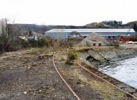Disused trackwork at the R M Supplies scrapyard, Inverkeithing, on 28 March 2008 with the northern approach arch of Jamestown Viaduct on the main line visible in the backgound. [Access by kind permission of RMS.]<br><br>[Grant Robertson 28/03/2008]