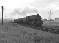 A black 5 on an eastbound oil train disturbs the golfers near Crookston in July 1962.<br><br>[Colin Miller 01/07/1962]