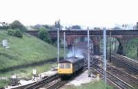 A Cravens 105 twin power car DMU to Colne leaves the slow lines south of Preston to climb up the Farington Curve. This view from Flag Lane is unchanged today (apart from the stock) and Bee Lane bridge in the picture is still an excellent vantage point. <br><br>[Mark Bartlett 12/06/1981]