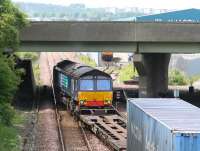 DRS 66419 crosses to the westbound line out of Grangemouth at Fouldubs Junction on 2 July with containers for Aberdeen. A second locomotive can be seen waiting for the road with a train in the W H Malcolm depot in the background beyond the M9 Motorway flyover.<br><br>[John Furnevel 02/07/2008]