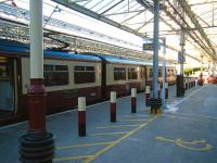 Saturday evening at Helensburgh Central on 14 June, with the glass platform canopies letting in the evening sunshine. View out along platform 1, occupied by the recently arrived 320312.<br><br>[Veronica Inglis 14/06/2008]