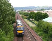 View over South Gyle towards Waverley on 26 June as a train from Fife passes. The rear of the shopping centre stands on the right and the platforms of South Gyle station are visible in the distance.<br><br>[John Furnevel 26/06/2008]