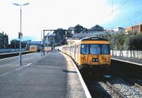 A DMU has just arrived at Springburn platform 2 from Cumbernauld in September 1985 as 303 032 waits in the bay with a Milngavie train.  <br><br>[David Panton /09/1985]