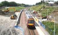 Looking west from the road bridge at Livingston North over ongoing development work on 25 July as a Bathgate - Newcraighall train prepares to leave. <br><br>[John Furnevel 25/07/2008]