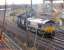 66142 comes off the Leith South branch at Portobello with a train of imported coal from Leith Docks to Cockenzie Power Station while in the background an unidentified 66 takes a train of empties down to the Docks for loading.<br><br>[Mark Poustie 25/11/2006]