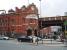 Deansgate station was known as Knott Mill and Deansgate until 1969, as can be seen from the very ornate panel above the street level entrance. The station is on the busy two track bottle neck section between Castlefield Junction and Manchester Piccadilly. <br><br>[Mark Bartlett 07/07/2008]