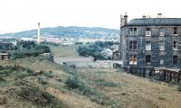 Looking north towards Corstorphine Hill circa 1972 with the site of Dalry Middle Junction on the other side of the gap left by the former railway bridge across Dalry Road. The diverging trackbeds of the old Caledonian routes to Haymarket West Junction (left) and Coltbridge Junction (right) can be clearly seen.<br><br>[John Furnevel //1972]