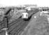 The 11.35 Glasgow Central - Stranraer service passing through Newton - on - Ayr station in April 1978. Falkland Yard is in the background and the line off to the left runs to Ayr Harbour.<br><br>[John Furnevel 07/04/1978]