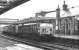 A short, sharp shower of rain sweeps across Dumfries during the morning of 24 March 1972. With electrification work in full swing on the WCML, locomotives 409+433 bring train 1M20, the diverted up <I>Royal Scot</I>, south through the station.<br><br>[John Furnevel 24/03/1972]