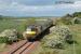 Locomotive hauled train passing Dirleton and heading south. The sea is in the distance.<br><br>[Ewan Crawford //]