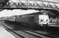 Class 50 no 439 runs through Dumfries with a diverted WCML service in May 1971, having just passed a freight heading north. Note the top of the old 'lighthouse' signal box can just be seen in the background above the first coach.<br><br>[John Furnevel 05/05/1971]