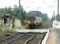 Looking west over Kirknewton level crossing in September 2002 as a train leaves for Glasgow Central.<br><br>[John Furnevel 03/09/2002]