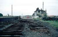 The end for Fakenham East station in October 1980. Since passenger services ceased in 1964 Fakenham had been the terminus of a freight spur from Dereham, latterly Wymondham. In the early 1980s, the line was truncated in stages back to North Elmham, starting with the closure of the Fakenham service two months earlier. That frequently used description for quick-off-the-mark railway demolition - <I>indecent haste</I> - seems quite appropriate here. The Mid Norfolk Railway aims to rebuild the line to Fakenham, but this site has now been completely built over.<br><br>[Mark Dufton 11/10/1980]