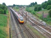 The pointwork around Farington Curve Junction can be clearly seen in this view south from Bee Lane bridge in August 2008 as a Pendolino heads north towards Preston. The Ormskirk route curves off to the far right while, in the centre, the line to Blackburn starts to climb before eventually turning east and crossing over the WCML.<br><br>[Mark Bartlett 01/08/2008]