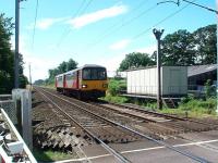 A Morecambe to Leeds service on its short WCML dash to the junction at Carnforth passes Bolton-le-Sands crossing, which is CCTV controlled from Hest Bank signal box. View south towards Hest Bank. <br><br>[Mark Bartlett 07/08/2008]