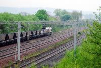 An empty 66 hauled train draws to a stop in the loops at Arkleston Junction, ready to be overtaken, just east of Paisley Gilmour Street. Tree growth now covers the former Renfrew line to the right and abortive line to Barrhead to the left.<br><br>[Ewan Crawford 10/05/2008]