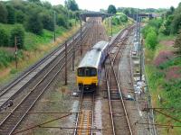 A Colne service with 150148 leaves the Up Slow line at Farington Curve Junction to climb the bank before heading east. At this point Ormskirk trains take the additional crossing to gain the former main line to Liverpool. <br><br>[Mark Bartlett 16/08/2008]