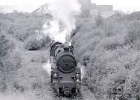 Standard class 4 2-6-0 No 76114 of Corkerhill shed leaving Braehead power station sidings and approaching Deanside with coal empties in 1966. Taken from the old Renfrew - Glasgow road which was cut when the KGV dock opened (Deanside station is behind the camera). The last of its class, 76114 was the last steam locomotive built at Doncaster works, having been completed there on 16 October 1957. <br><br>[Colin Miller //1966]