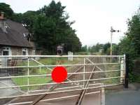 Although the Windermere branch is now operated as a <I>one engine in steam</I> siding the level crossing near Burneside station is still protected by two semaphores. View towards Burneside station, which is just round the corner, and Windermere. <br><br>[Mark Bartlett 30/08/2008]