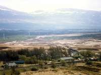 A northbound freight approaches Rannoch station over the wastes of Rannoch Moor. Note the camping coach bottom left. There was a siding here with a turntable (the pit it just to the right of the coach).<br><br>[Ewan Crawford //1990]