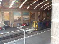The trainshed at Penzance is an impressive structure but quite gloomy inside, which means that the murals on the walls are not always seen to best effect. 150233 waits to return to Plymouth on a FGW stopping service in September 2008.<br><br>[Mark Bartlett 18/09/2008]
