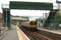 Temporary footbridge to platform 4 at Motherwell seen on 17 September with 318 252 recently arrived with a service for Lanark via Holytown. The group at the end of platform 3 standing beneath the now closed original structure were engaged in discussions regarding its replacement.<br><br>[David Panton 17/09/2008]
