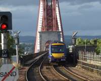 Sunshine from the south as this Aberdeen to Edinburgh service leaves the towering structure of the Forth Bridge at Dalmeny<br><br>[Brian Forbes /09/2008]