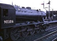 Austerity 2-8-0 90386 stands at Stirling on 11 April 1966 with the SLS/BLS/SLPF <I>Scottish Rambler No 5</I> railtour. The locomotive had brought the train from Glasgow Queen Street and was in the process of handing over to J38 65914 for the next stage of the journey, a circuitous route to Bathgate Junction.<br><br>[Robin Barbour Collection (Courtesy Bruce McCartney) 11/04/1966]